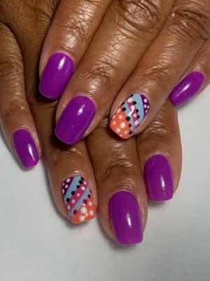 Glossy magenta purple nails with diagonal multicolor striped and polka-dot accent nails